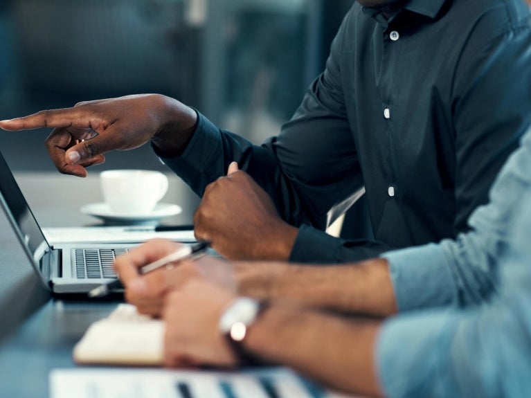 People sitting in front of a laptop