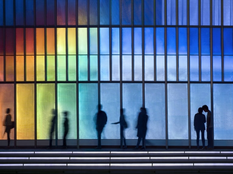 People in front of a colorful wall