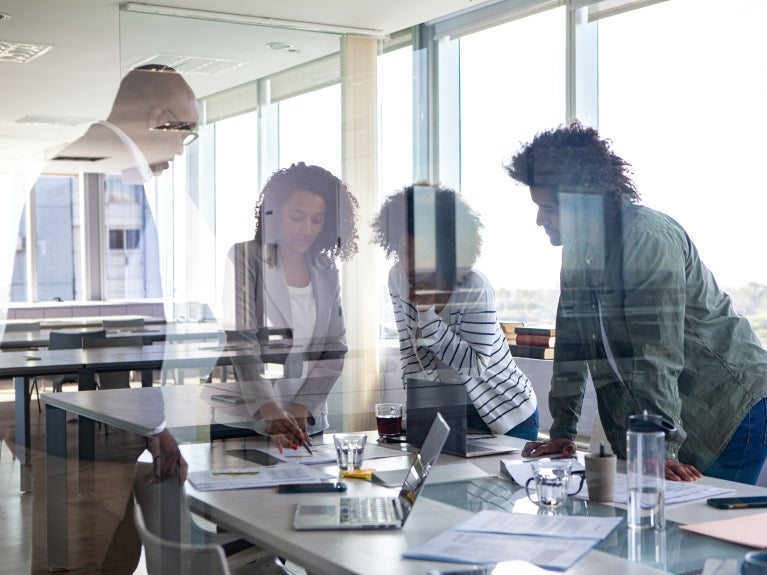 people gathered around a workspace