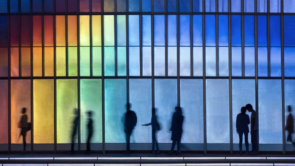 People in front of a colorful wall