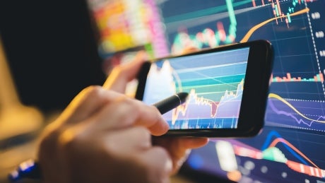 image of data on computer screen and phone