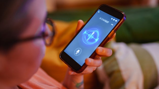 Woman speaking to AI chatbot on smartphone